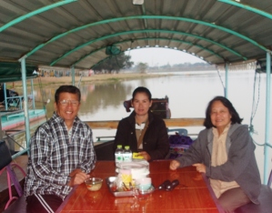 On our flat bottom boat with our captain and bird watching guide Nong Moo (Miss Piggy) 
